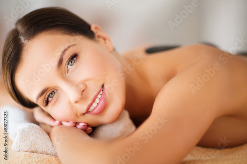 beautiful woman in spa salon with hot stones