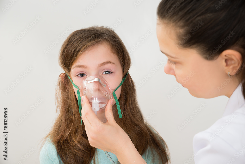Doctor Holding Inhaler Mask For Girl Breathing Doctor Holding Inhaler Mask For Girl Breathing