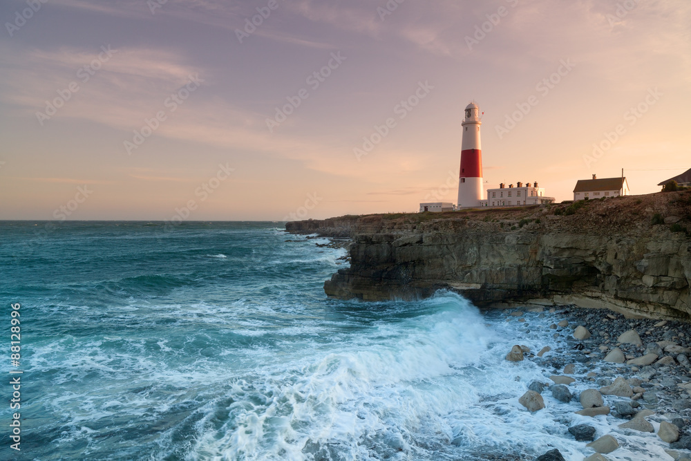 Stormy seas crash over the rocks with the lighthouse in the background at Portland Bill in Dorset.Stormy seas crash over the rocks with the lighthouse in the background at Portland Bill in Dorset.