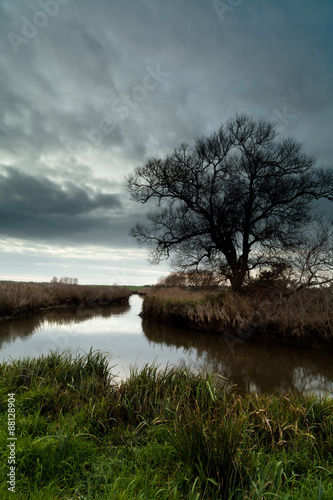 Dark skies over a river