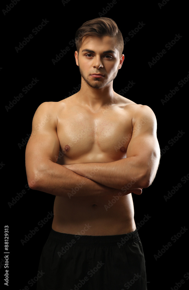 Fototapeta premium Muscle young man on dark background