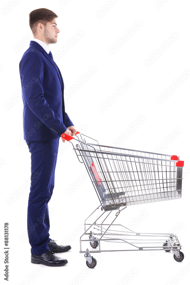 Young man with empty shopping cart, isolated on white Young man with empty shopping cart, isolated on white