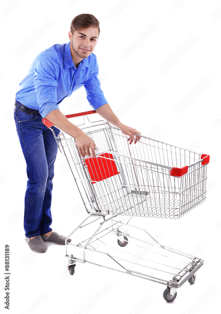 Young man with empty shopping cart, isolated on white Young man with empty shopping cart, isolated on white