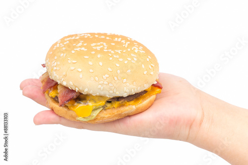 Burger on female hand with isolated background.