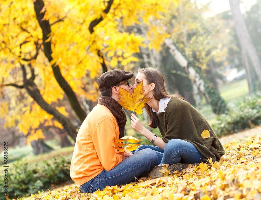 Cheerful young couple enjoy break on sunny autumn day in park Cheerful young couple enjoy break on sunny autumn day in park