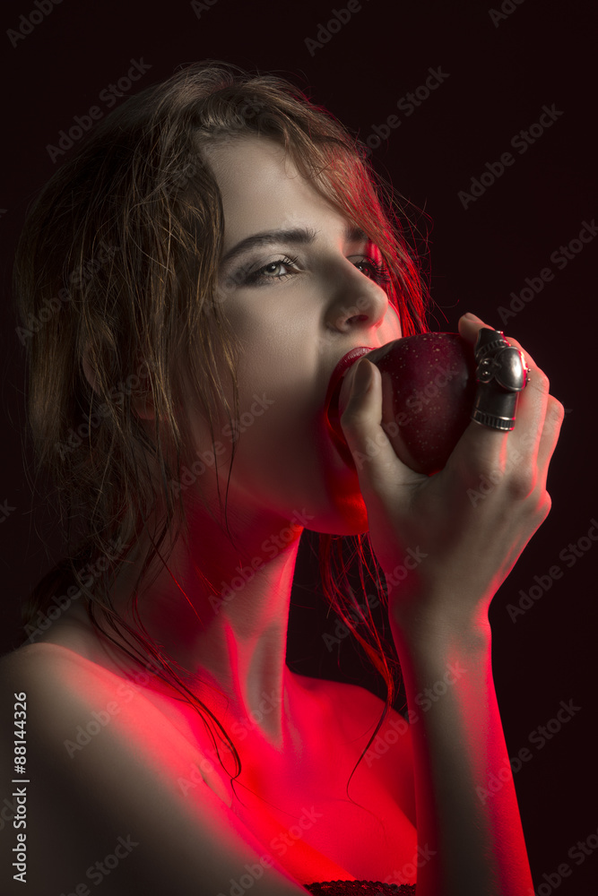Naklejka premium sexy girl biting red apple
