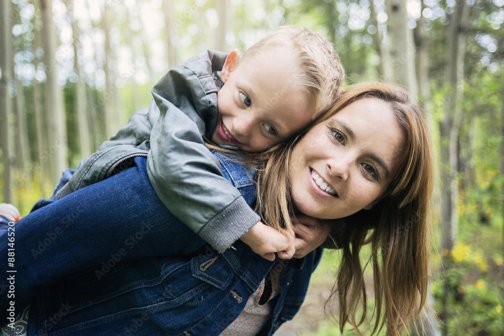 Fototapeta premium Mother and son in forest having fun