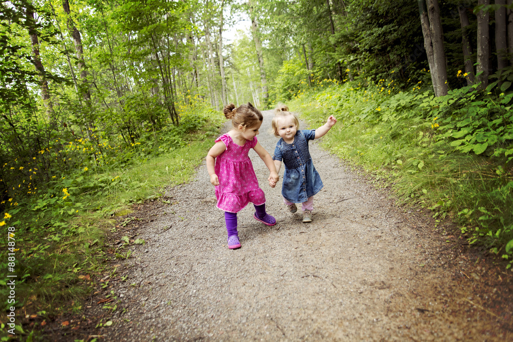 cute little sisters having fun on a summer day cute little sisters having fun on a summer day