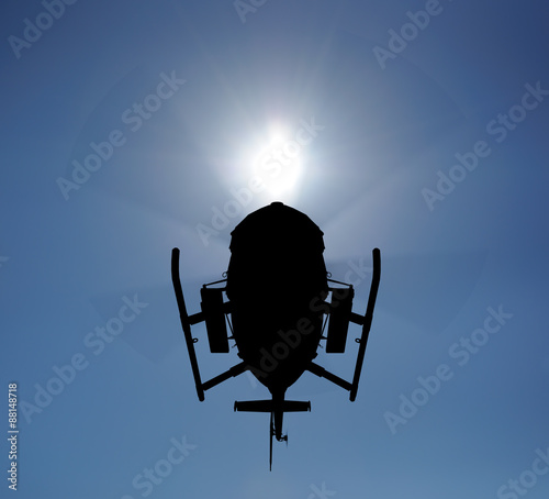 Helicopter silhouette in the sky