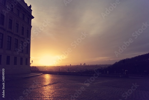 Early morning sunrise over Prague seen from the Prague castle; cityscape. Image edited in faded, retro, Instagram style with red filter; nostalgic vintage travel concept.