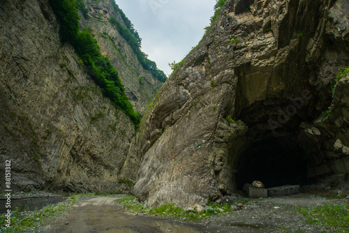 The entrance to the cave.Mountains in the clouds.The Caucasus. .Russia. photo
