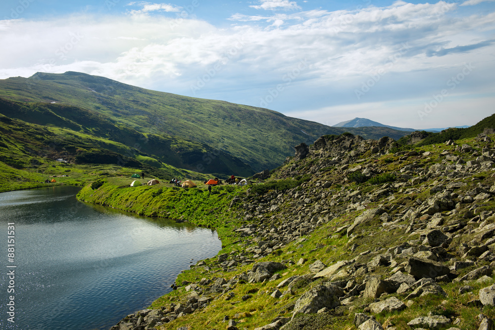 Camping near mountain lake in tents