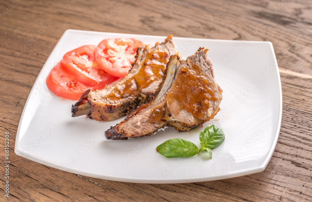 Portion of grilled pork ribs in barbecue sauce Portion of grilled pork ribs in barbecue sauce
