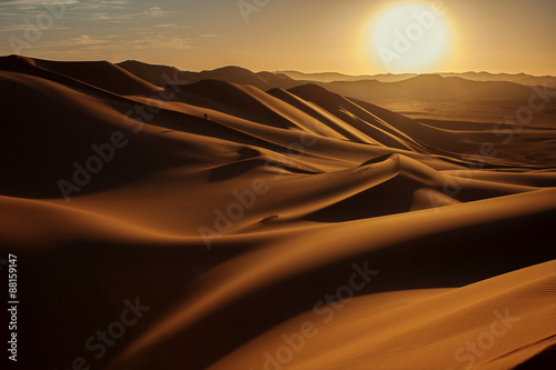 Traveller in Sahara desert. Small person shows the vastness of the desert.