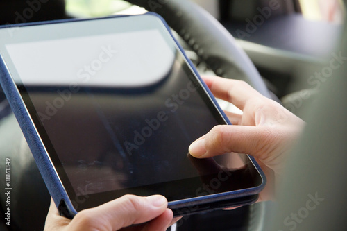 Woman Sitting in the Car and Using digital tablet