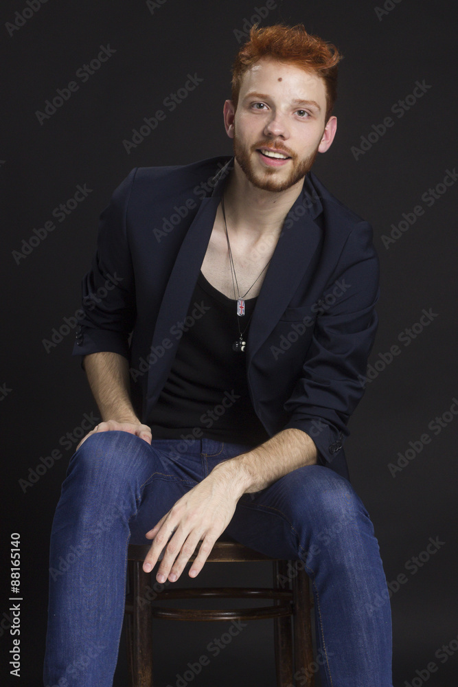 Ginger guy sitting in chair, wearing jacket. Ginger guy sitting in chair, wearing jacket.