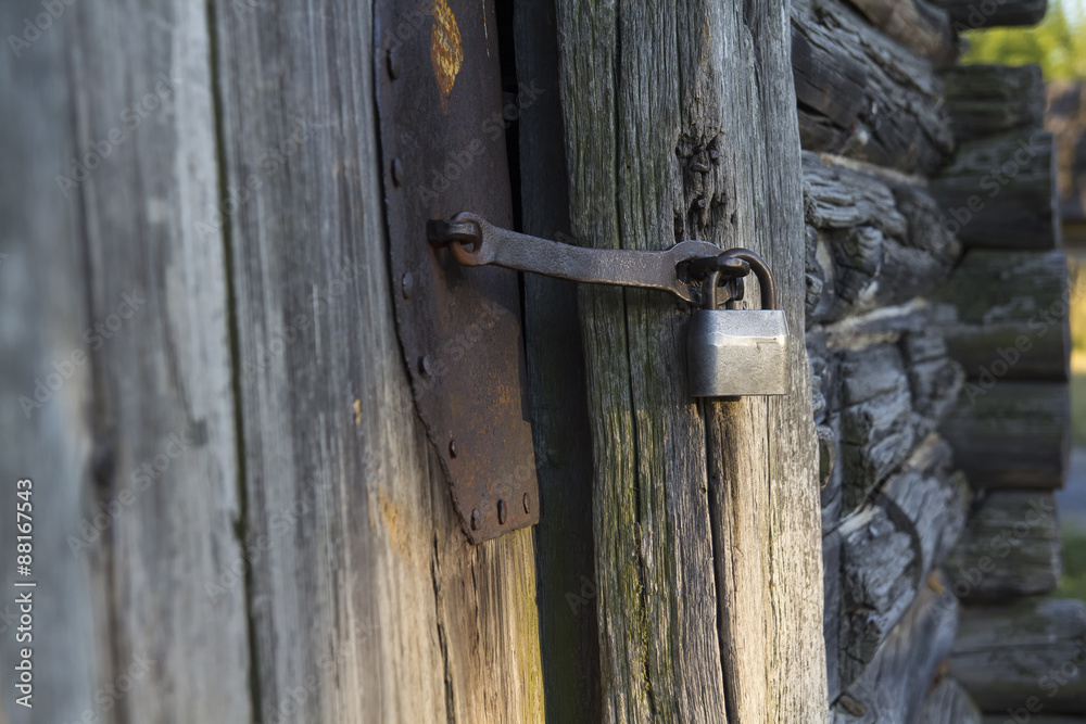 Old house. Door closed on the padlock