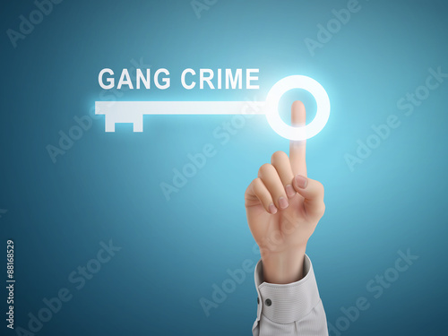 male hand pressing gang crime key button