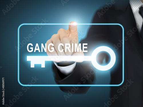 male hand pressing gang crime key button