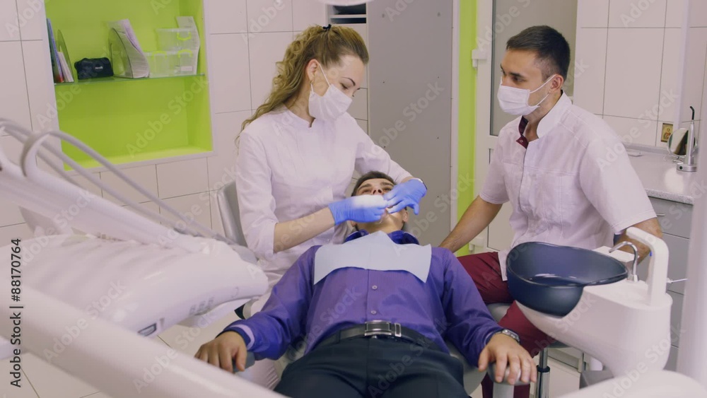 The dentist holds the manipulation with the patient