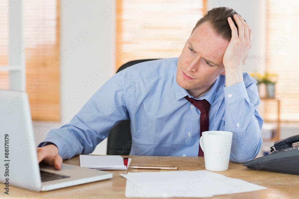 Stressed businessman working at his desk Stressed businessman working at his desk
