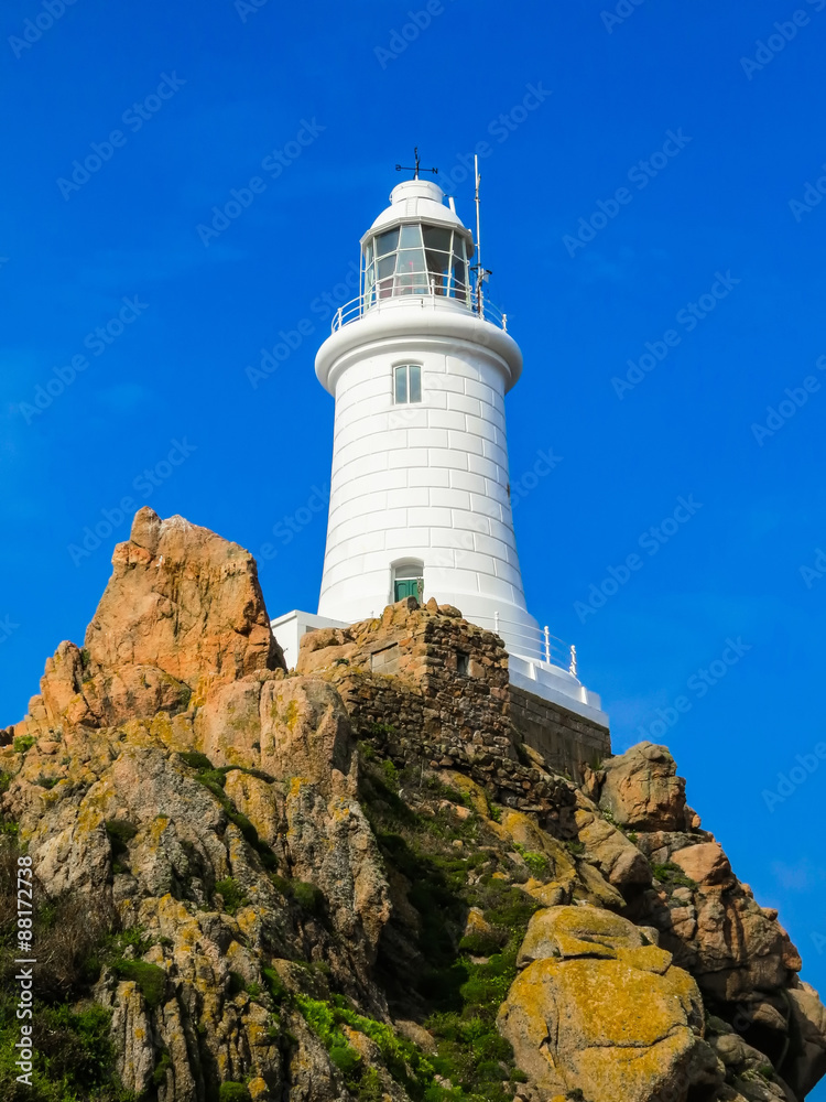 White lighthouse on the rock