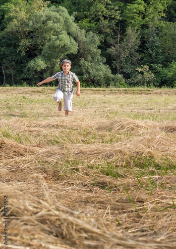 Wallpaper Mural Cute boy running on the meadow, allergy free. Enjoying in nature. Freedom concept. Torontodigital.ca