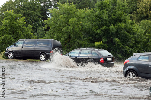 Cars trying to drive against flood on the street in Gdansk  Poland