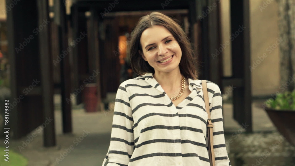 Portrait of young happy pretty woman in the city
Portrait of young happy pretty woman in the city