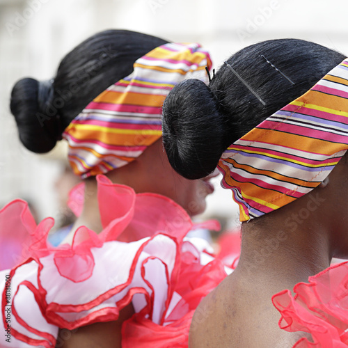 Photography Lateral view of two young woman wearing one of the folk costume of Cuba