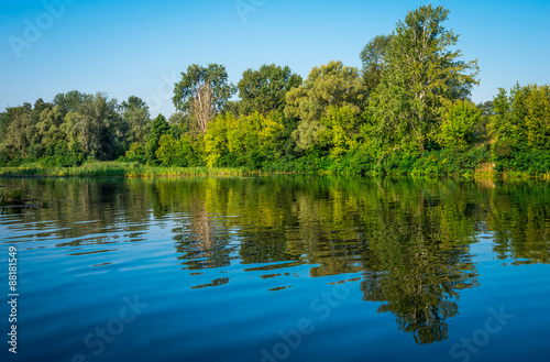 Sunny day on a calm river in summer © fotolesnik