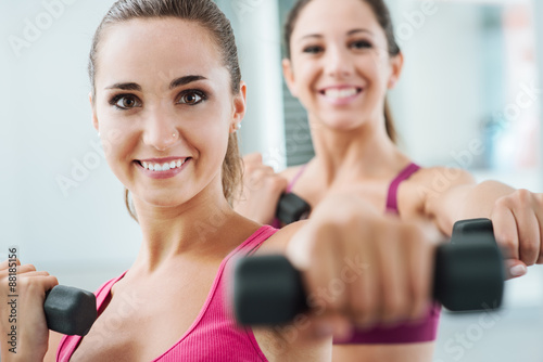 Cheerful women exercising at the gym