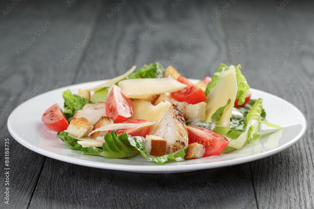 caesar salad with chicken on oak table caesar salad with chicken on oak table