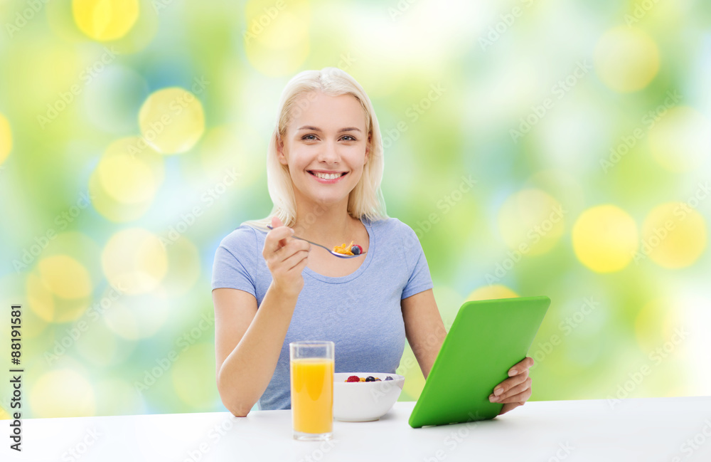 smiling woman with tablet pc eating breakfast smiling woman with tablet pc eating breakfast