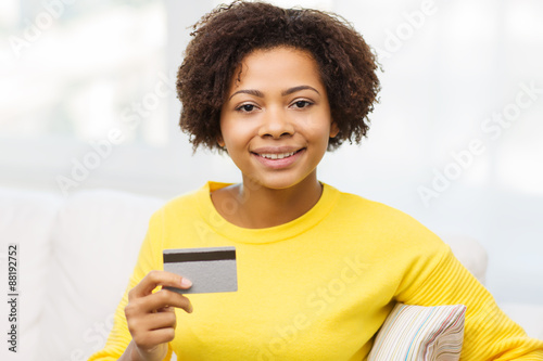 happy african woman with credit or debit card