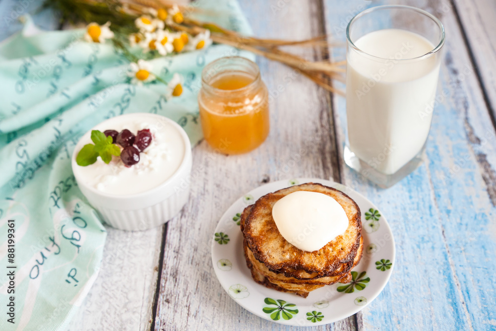 Healthy breakfast with oatmeal pancakes, beaded cheese and milk Healthy breakfast with oatmeal pancakes, beaded cheese and milk