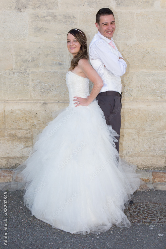 wedding pair hugging and kissing at the wall stone wedding pair hugging and kissing at the wall stone