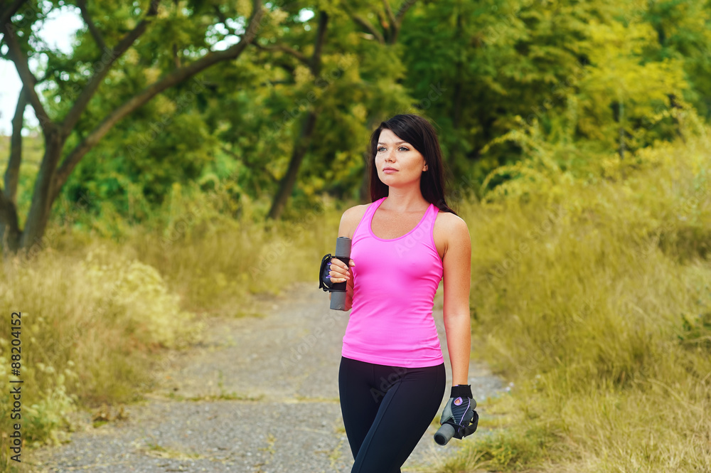 The girl is engaged in sports in the Park The girl is engaged in sports in the Park