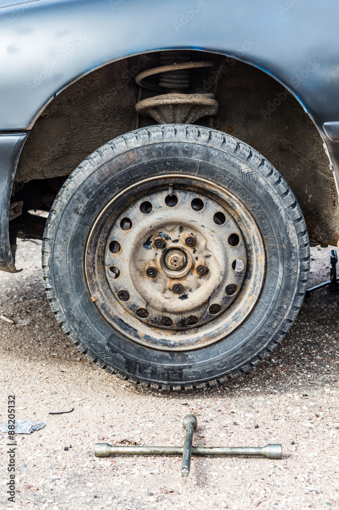 Rusty car wheel with a special key