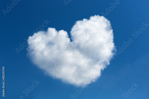 Heart shaped clouds on blue sky background