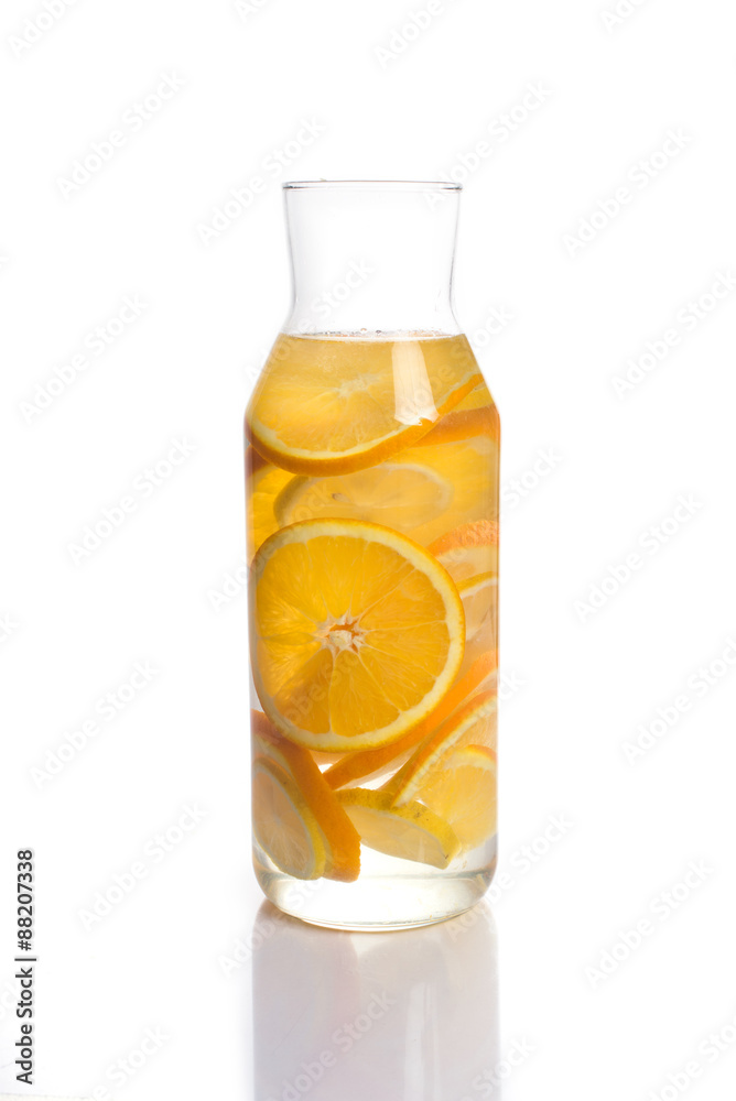 orange and lemon infused water in a glass decanter orange and lemon infused water in a glass decanter