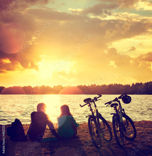 Romantic Couple with Bikes by the Lake