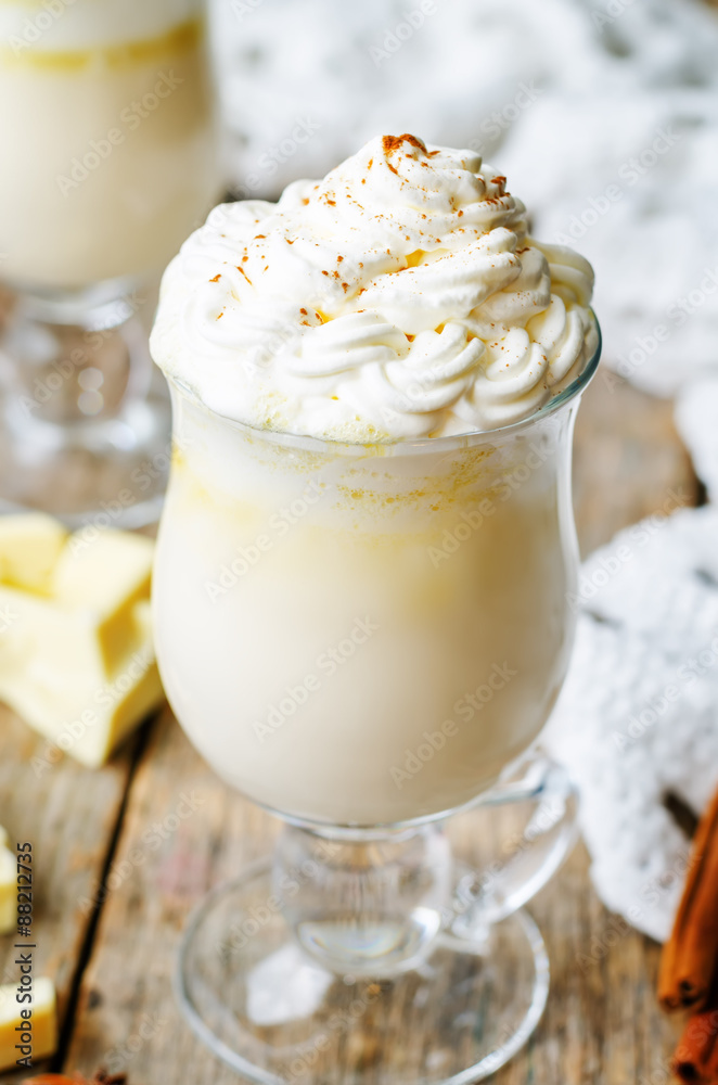 hot white chocolate decorated with whipped cream with cinnamon.