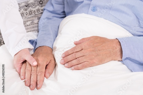 Nurse supporting old male patient photo