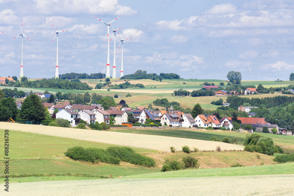 German village with houses, windmills and corn fields