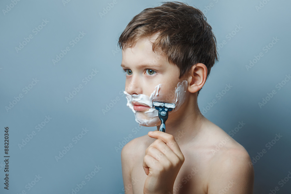 Boy  teenager European  appearance decade  shaves  face on a  gr