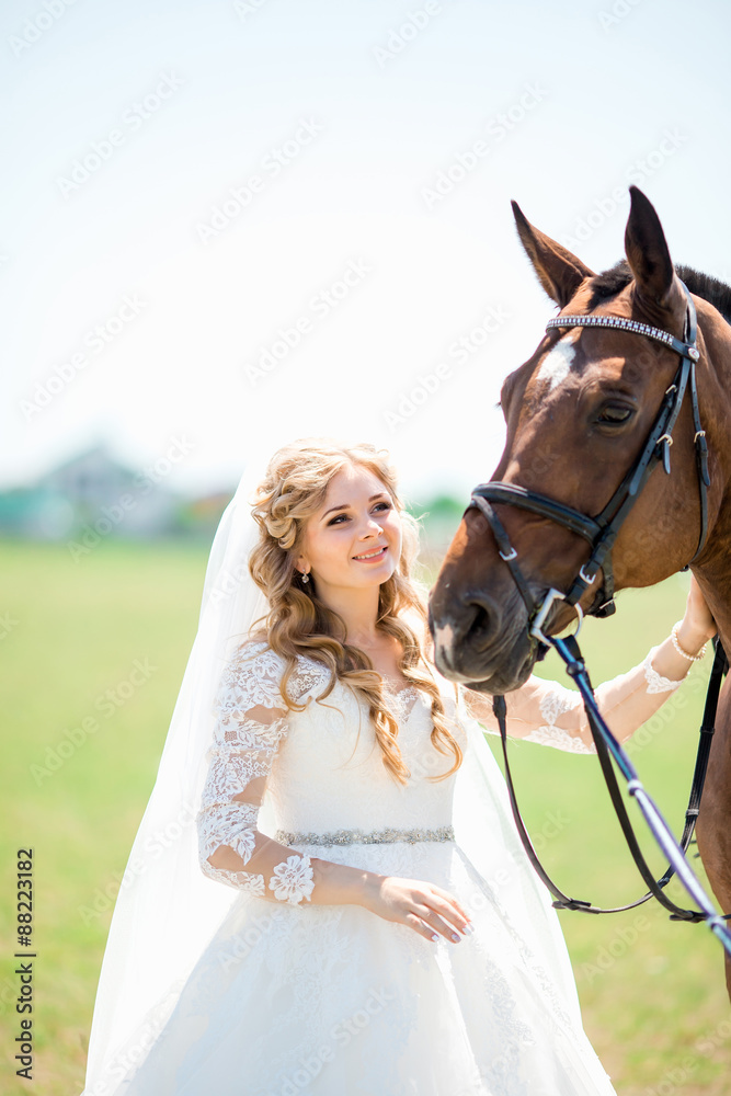 Obraz premium portrait of a beautiful bride and horse