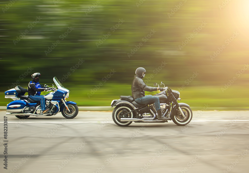 two bikers riding unknown motorbike with blur movement, speed co