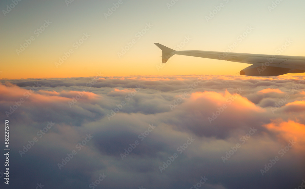 Airplane Wing in Flight from window, sunset sky Airplane Wing in Flight from window, sunset sky