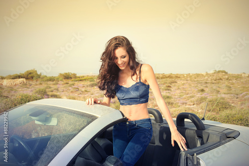 Girl sitting in an elegant car